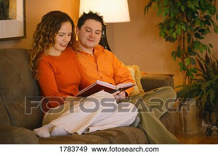 Young Couple REading together View Large Photo Image Stock Photo - Young Couple REading together. Fotosearch