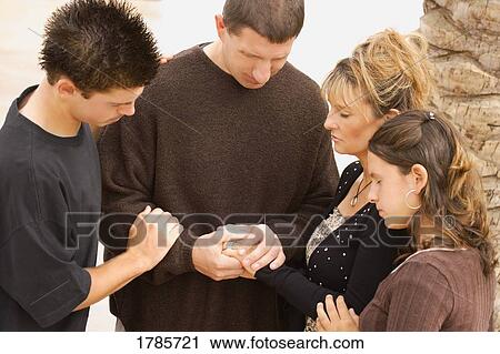 A group of young people praying together View Large Photo Image Stock Image - A group of young people praying together. Fotosearch