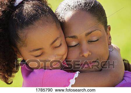 A mother and daughter embracing View Large Photo Image Stock Image - A mother and daughter embracing. Fotosearch