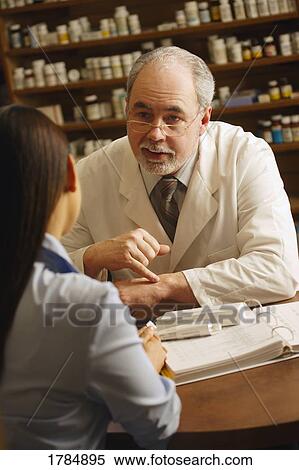 A pharmacist giving advice to patient View Large Photo Image Stock Photography - A pharmacist giving advice to patient. Fotosearch