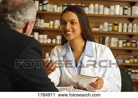 A pharmacist with a patient View Large Photo Image Stock Image - A pharmacist with a patient. Fotosearch