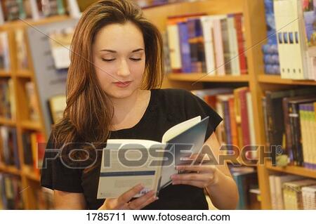Stock Image - A young adult reading book. Fotosearch