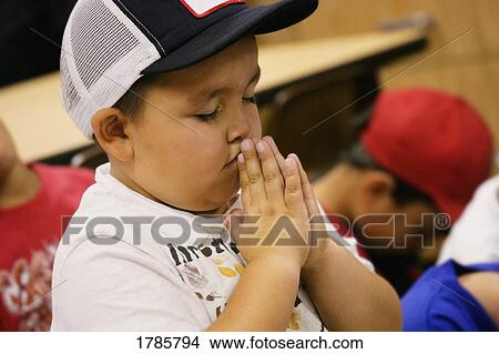 A young boy in prayer View Large Photo Image Picture - A young boy in prayer. Fotosearch
