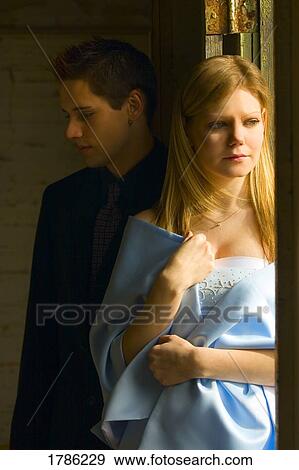 Stock Photo - A young couple dressed in formal clothing. Fotosearch