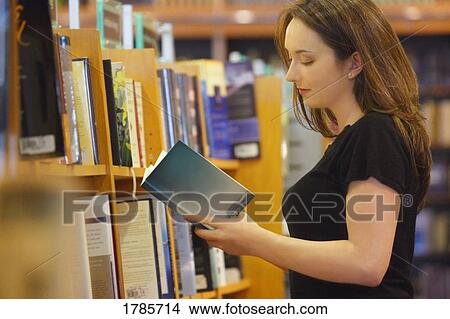 Picture - A Young woman reading a book. Fotosearch