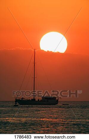 Boat silhouetted against sun and sky View Large Photo Image Stock Image - Boat silhouetted against sun and sky. Fotosearch
