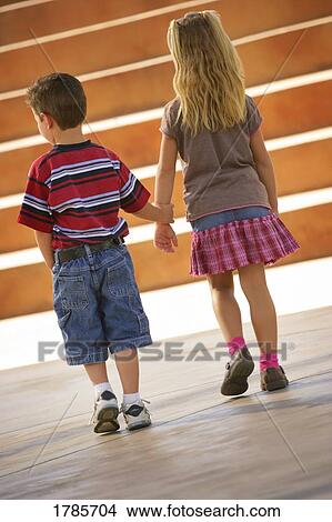 Boy and girl holding hands View Large Photo Image Picture - Boy and girl holding hands. Fotosearch
