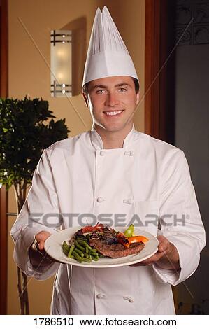 Chef showing off plate of food View Large Photo Image Stock Image - Chef showing off plate of food. Fotosearch