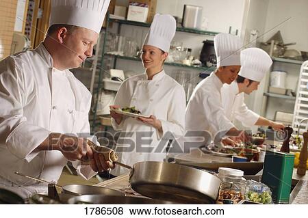 Chef's preparing food in a kitchen View Large Photo Image Stock Photo - Chef's preparing food in a kitchen. Fotosearch