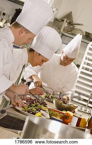 Stock Photograph - Chefs working in kitchen. Fotosearch