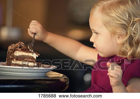 Stock Photo - Child eating cake. Fotosearch