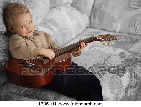 Child playing guitar View Large Photo Image Picture - Child playing guitar. Fotosearch
