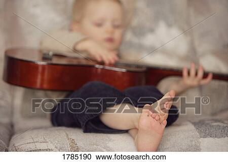 Child Playing guitar View Large Photo Image Stock Image - Child Playing guitar. Fotosearch