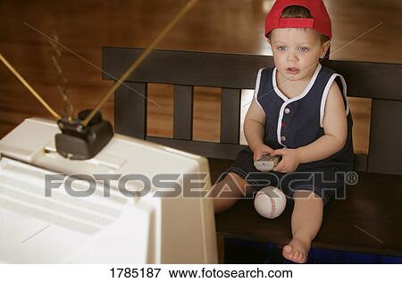 Child watching sports game on television View Large Photo Image Stock Photo - Child watching sports game on television. Fotosearch