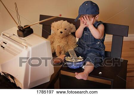 Stock Photo - Child watching television. Fotosearch