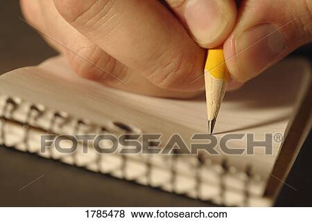 Stock Photo - Closeup of hand writing with pencil. Fotosearch