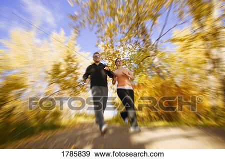 Couple jogging in the autumn View Large Photo Image Stock Photo - Couple jogging in the autumn. Fotosearch