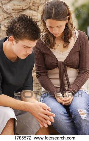 Stock Image - Couple praying. Fotosearch