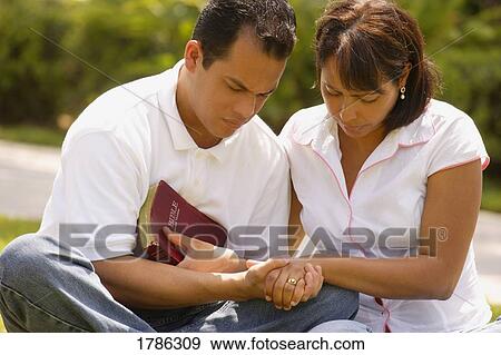 Couple praying together View Large Photo Image Stock Photo - Couple praying together. Fotosearch