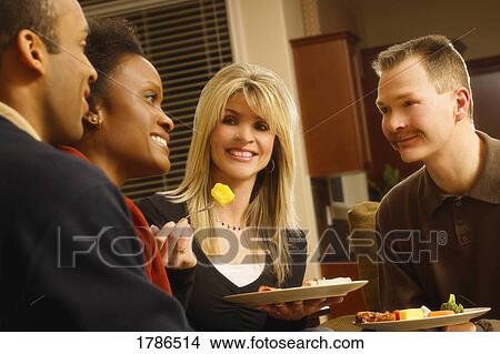 Couples sharing a meal together View Large Photo Image Picture - Couples sharing a meal together. Fotosearch