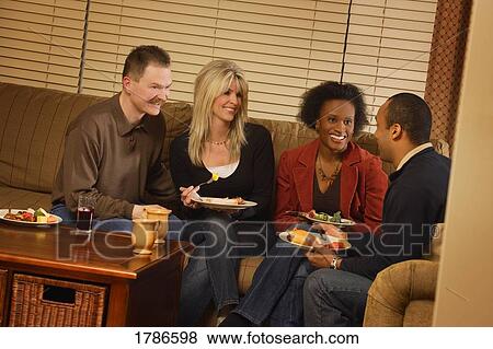 Stock Photo - Couples visiting over food. Fotosearch