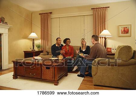 Stock Photo - Couples visiting over food. Fotosearch