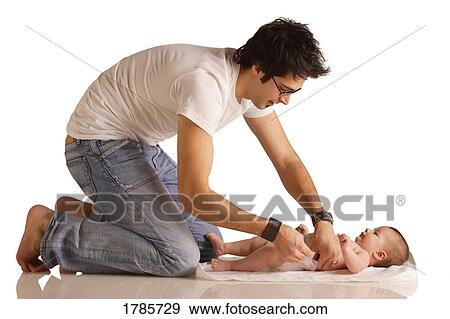 Stock Photo - Dad changing diaper. Fotosearch