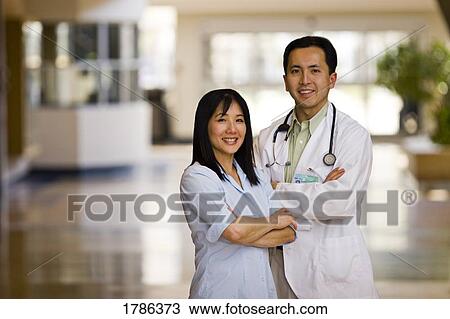 Stock Image - Doctor and nurse portrait in medical facility. Fotosearch