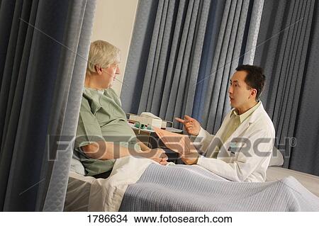 Doctor instructing patient View Large Photo Image Picture - Doctor instructing patient. Fotosearch