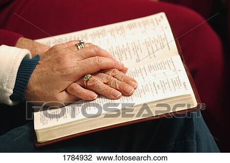 Stock Image - Elderly women reading a Bible. Fotosearch