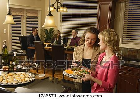 Entertaining guests View Large Photo Image Stock Photo - Entertaining guests. Fotosearch