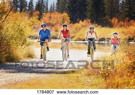 Stock Photo - Family cycling together. Fotosearch