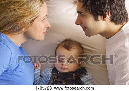 Stock Image - Family in bed together. Fotosearch