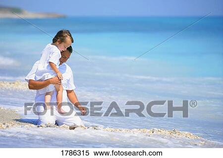 Stock Photography - Father and child on the beach. Fotosearch