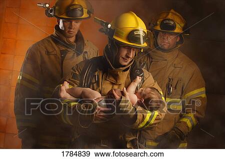 Stock Photo - Fire fighters rescuing a baby. Fotosearch