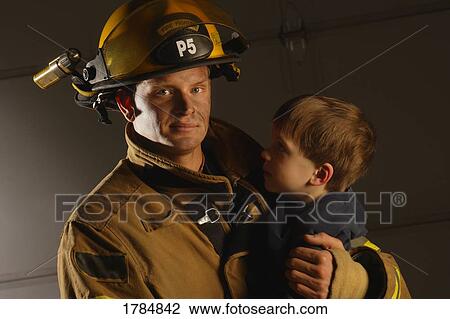 Fireman holding child View Large Photo Image Stock Image - Fireman holding child. Fotosearch