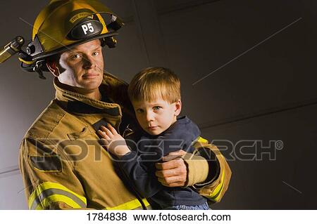 Fireman holding child View Large Photo Image Stock Photo - Fireman holding child. Fotosearch