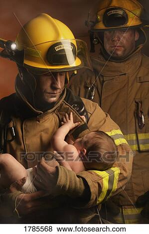 Firemen rescuing a baby View Large Photo Image Stock Photo - Firemen rescuing a baby. Fotosearch
