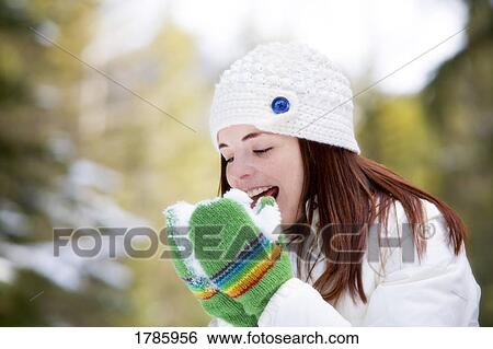 Stock Photograph - Girl eating snow. Fotosearch