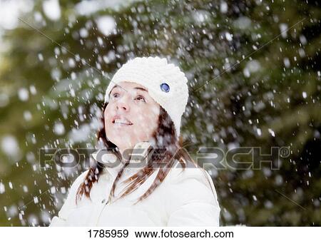 Stock Photo - Girl under snow flakes. Fotosearch