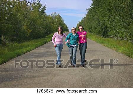 Girls walking together View Large Photo Image Stock Photography - Girls walking together. Fotosearch