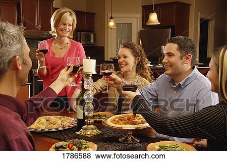 Group having dinner together View Large Photo Image Stock Photo - Group having dinner together. Fotosearch