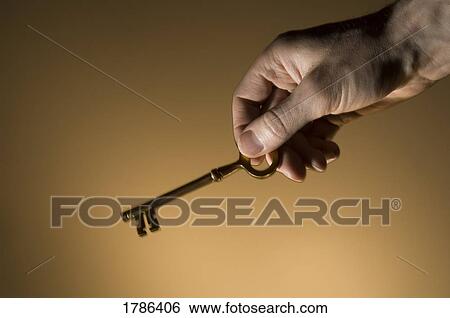 Stock Photograph - Hand with key. Fotosearch