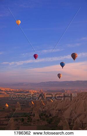 Stock Image - Hot air balloons over canyon. Fotosearch