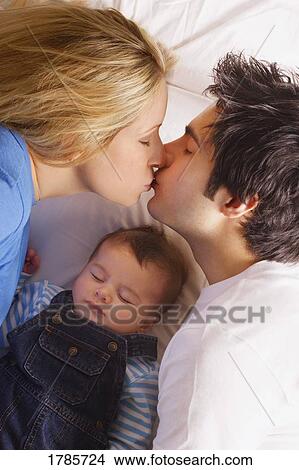 Kissing parents View Large Photo Image Picture - Kissing parents. Fotosearch
