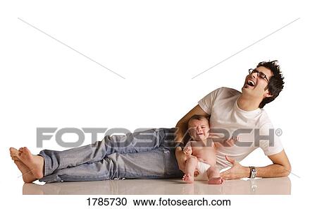 Stock Image - Laughing dad with baby. Fotosearch