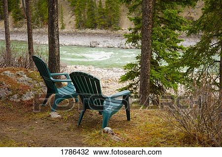 Lawn chairs situated by the lake View Large Photo Image Stock Image - Lawn chairs situated by the lake. Fotosearch