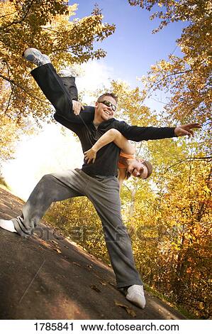 Man holds woman over his shoulder View Large Photo Image Stock Image - Man holds woman over his shoulder. Fotosearch