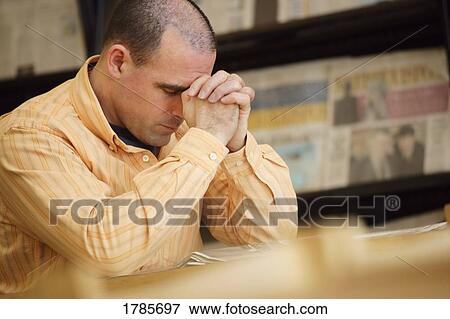 Man praying in library View Large Photo Image Stock Photo - Man praying in library. Fotosearch