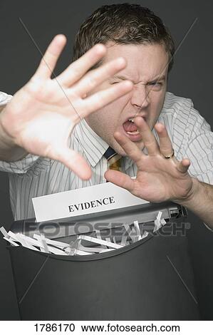 Stock Image - Man shredding evidence. Fotosearch